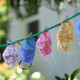 For sale masks are seen displayed on a clothesline in the front yard of a house in Los Angeles on July 20, 2020.